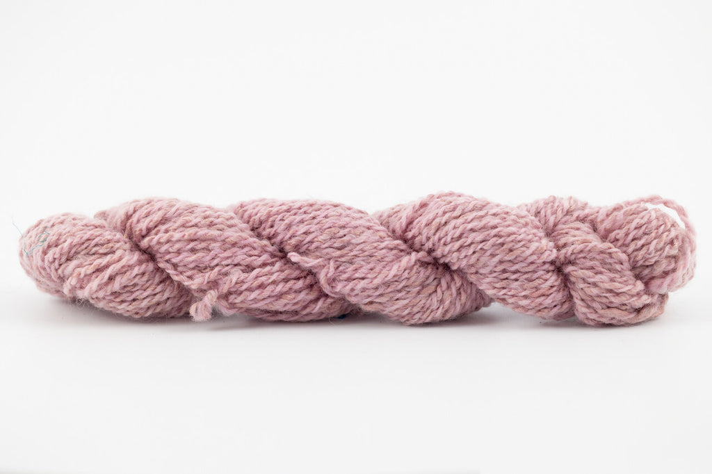A lavender skein of Wensleydale Muga silk naturally dyed with cochineal.