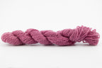 A purple skein of Wensleydale Muga silk naturally dyed with cochineal.
