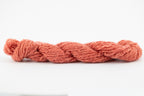 A coral skein of Wensleydale Muga silk naturally dyed with madder root.