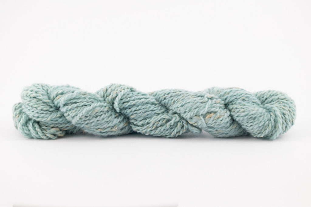 A blue skeing of skein of Wensleydale Muga silk naturally dyed with indigo.