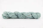 A blue skeing of skein of Wensleydale Muga silk naturally dyed with indigo.