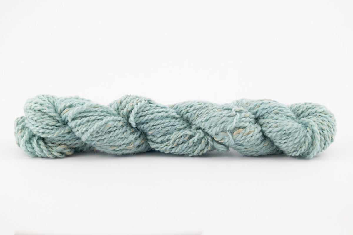A blue skeing of skein of Wensleydale Muga silk naturally dyed with indigo.