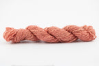 A light coral skein of Wensleydale Muga silk naturally dyed with madder root.