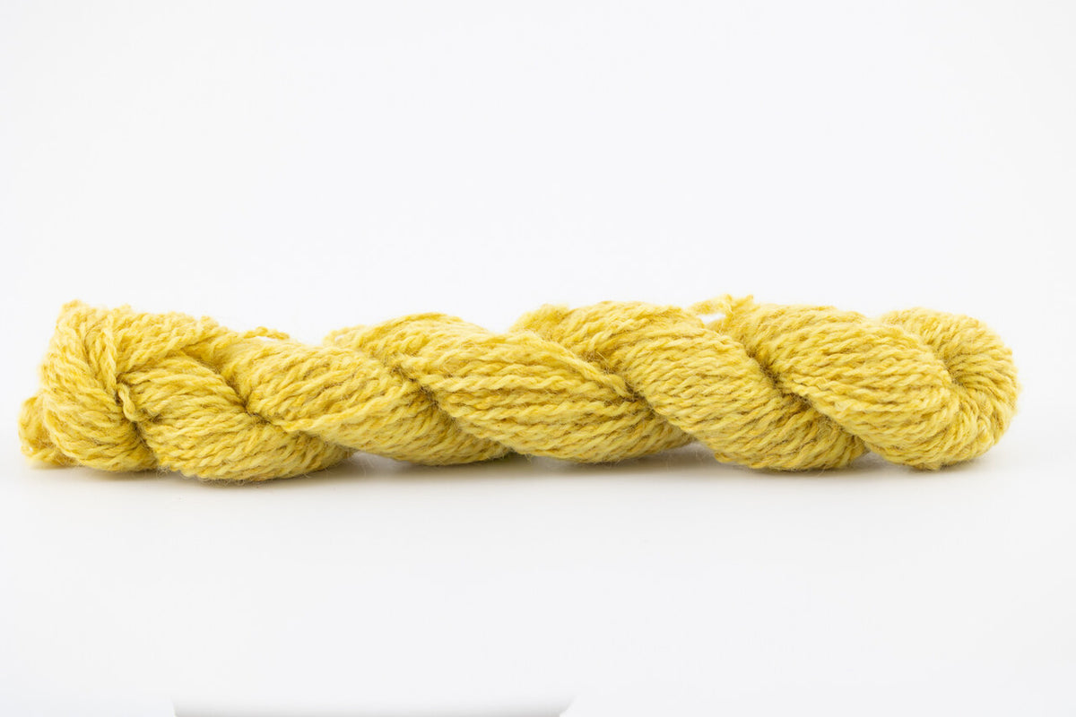 A bright yellow skein of Wensleydale Muga silk naturally dyed with weld.