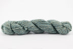 A skein of teewater and muga silk naturally dye with indigo to light blue color.