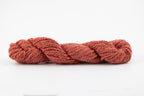 A skein of tesswater and muga silk naturally dyed with madder root to a brick red color.