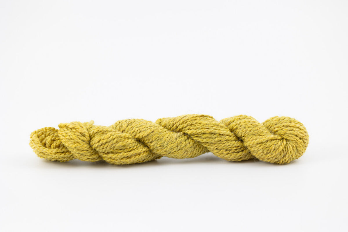 A skein of teewater and muga silk naturally dye with weld to a bright yellow color.