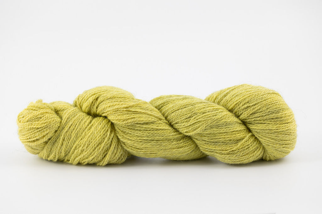 A skein of a blend of corriedale and gotland wool naturally dyed with weld to a bright yellow color.