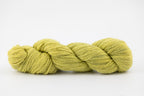 A skein of a blend of corriedale and gotland wool naturally dyed with weld to a bright yellow color.