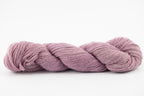 A skein of a blend of corriedale and gotland wool naturally dyed with cochineal to a lavender color.