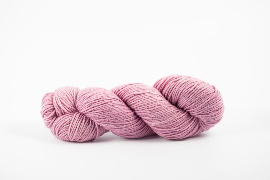 A skein of shaniko wool naturally dyed with cochineal to a lavender color.