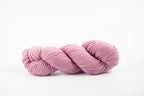 A skein of shaniko wool naturally dyed with cochineal to a lavender color.