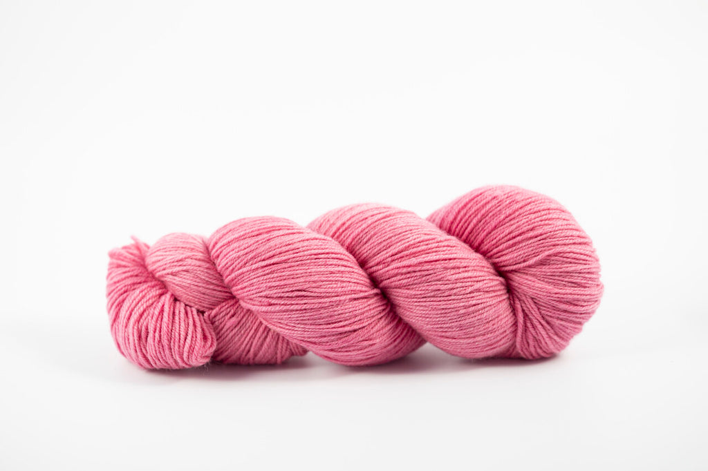 A pink skein of Shaniko wool yarn naturally dyed with cochineal. 