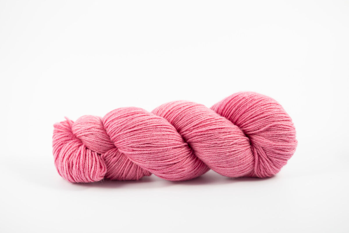A pink skein of Shaniko wool yarn naturally dyed with cochineal. 