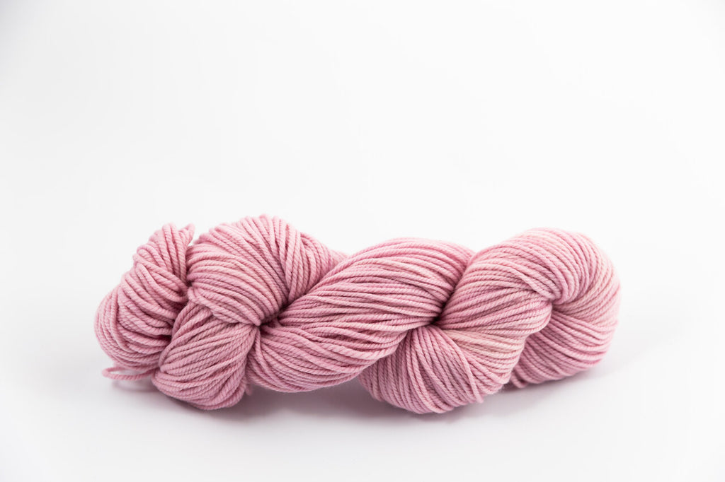 A lavender skein of Shaniko wool and silk worsted weight yarn naturally dyed with cochineal.