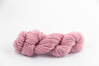A lavender skein of Shaniko wool and silk worsted weight yarn naturally dyed with cochineal.