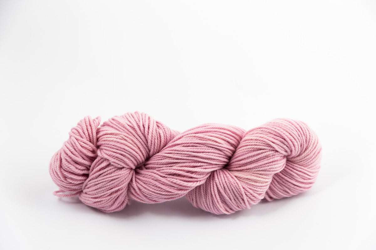 A lavender skein of Shaniko wool and silk worsted weight yarn naturally dyed with cochineal.