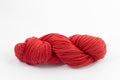 A red skein of Shaniko wool and silk worsted weight yarn naturally dyed with sappanwood.