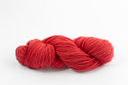 A red skein of Shaniko wool and silk worsted weight yarn naturally dyed with sappanwood.