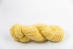 A light yellow skein of Shaniko wool and silk worsted weight yarn naturally dyed with marigold.