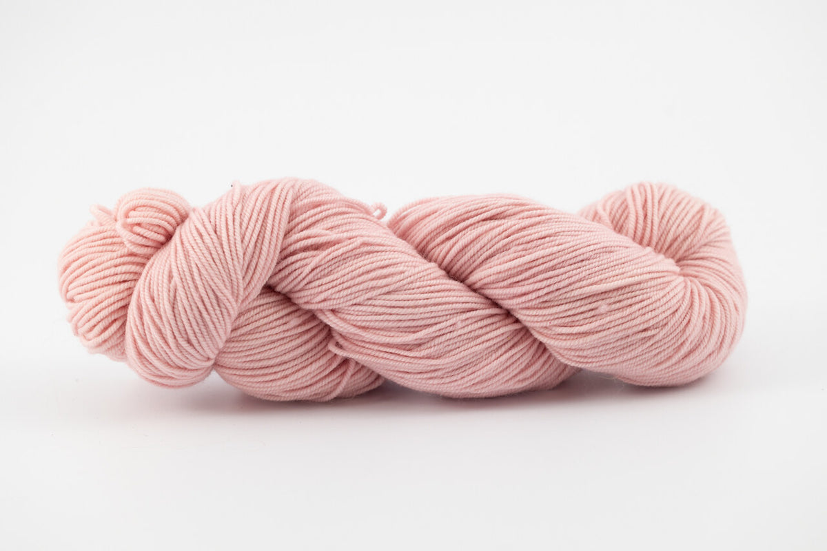 A light pink skein of Shaniko wool and silk yarn naturally dyed with cochineal.