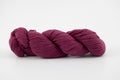 A purple skein of Shaniko wool and silk yarn naturally dyed with cochineal.