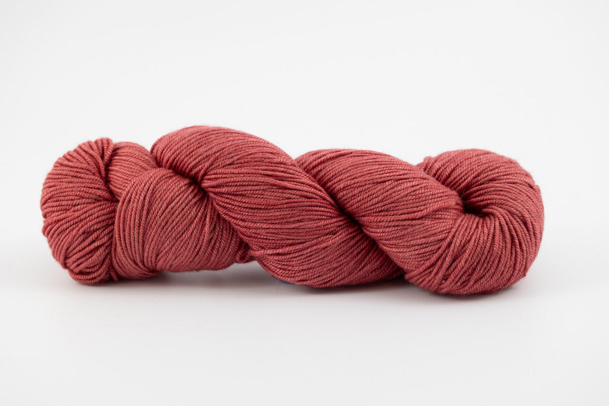 A copper skein of Shaniko wool and silk yarn naturally dyed with lac.