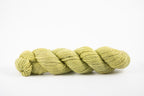 A skein of a blend of corriedale and gotland wool naturally dyed with weld to a bright yellow color.